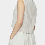 Side and back close up of speckle beige ribbed knit vest with cropped length and collar detail