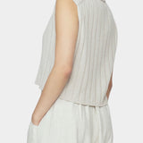 Side and back close up of speckle beige ribbed knit vest with cropped length and collar detail