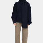 Front view of the Navy Black Long Wool Scarf wrapped high around the neck with one end hanging down at YUCCA Denver