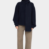 Front view of the Navy Black Long Wool Scarf wrapped high around the neck with one end hanging down at YUCCA Denver