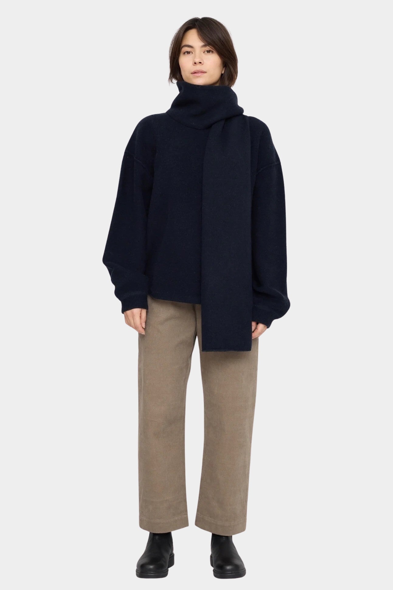 Front view of the Navy Black Long Wool Scarf wrapped high around the neck with one end hanging down at YUCCA Denver