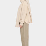 Side view of the off-white Long Wool Scarf wrapped around the neck with long ends draped front and back
