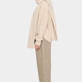 Side view of the off-white Long Wool Scarf wrapped around the neck with long ends draped front and back