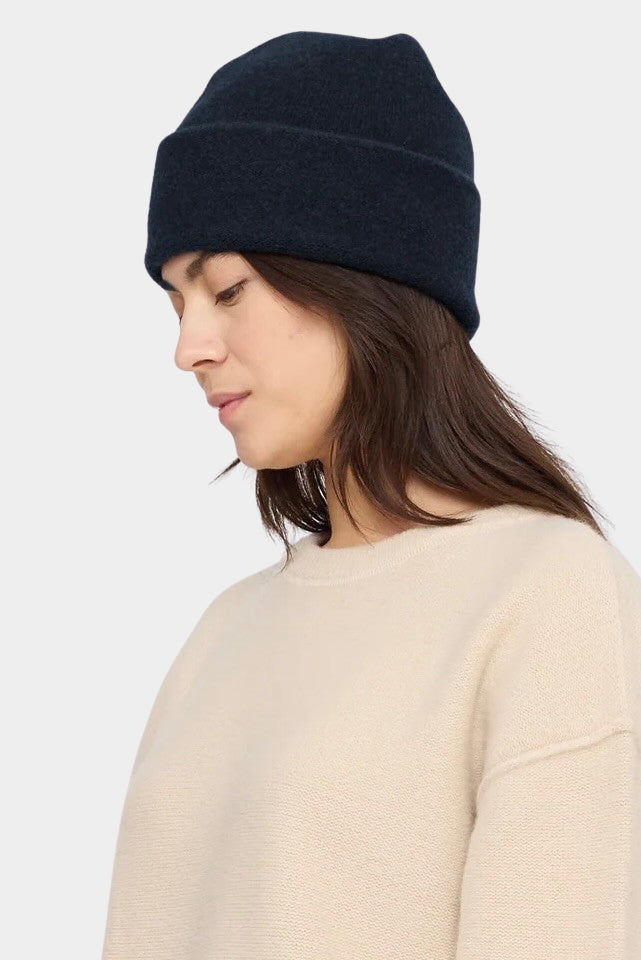7115 by Szeki Merino Beanie Navy Black worn with a folded cuff, shown from the side at YUCCA Denver.