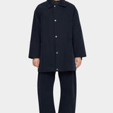 7115 by Szeki Mid-Length Chore Coat Navy front view fastened with snap buttons.