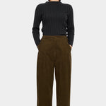 7115 by Szeki Mock Neck Ribbed Long Sleeves Charcoal tucked into brown corduroy trousers.