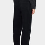 Front view of the black Signature Elastic Pull-Up Trouser with a rounded leg and tapered ankle at YUCCA Denver