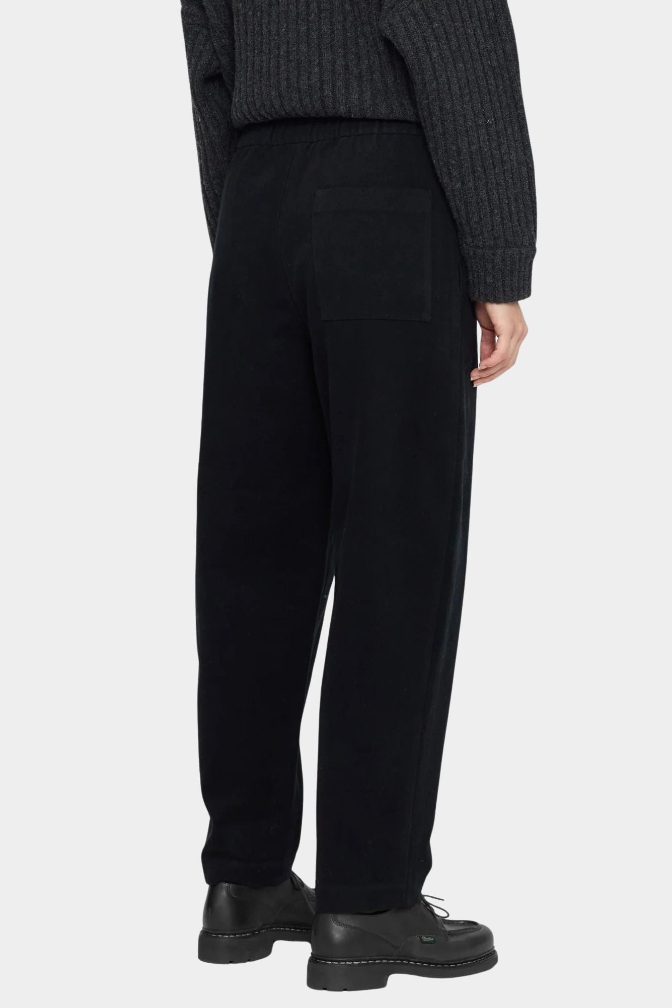 Front view of the black Signature Elastic Pull-Up Trouser with a rounded leg and tapered ankle at YUCCA Denver