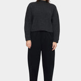 Model wearing the black elastic waist trouser with a charcoal ribbed sweater and black lace-up shoes