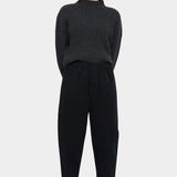Front view of the black Signature Elastic Pull-Up Trouser with a rounded leg and tapered ankle at YUCCA Denver