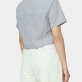 Back and side close up of navy striped cropped shirt with short sleeves and back yoke styled with ivory trousers
