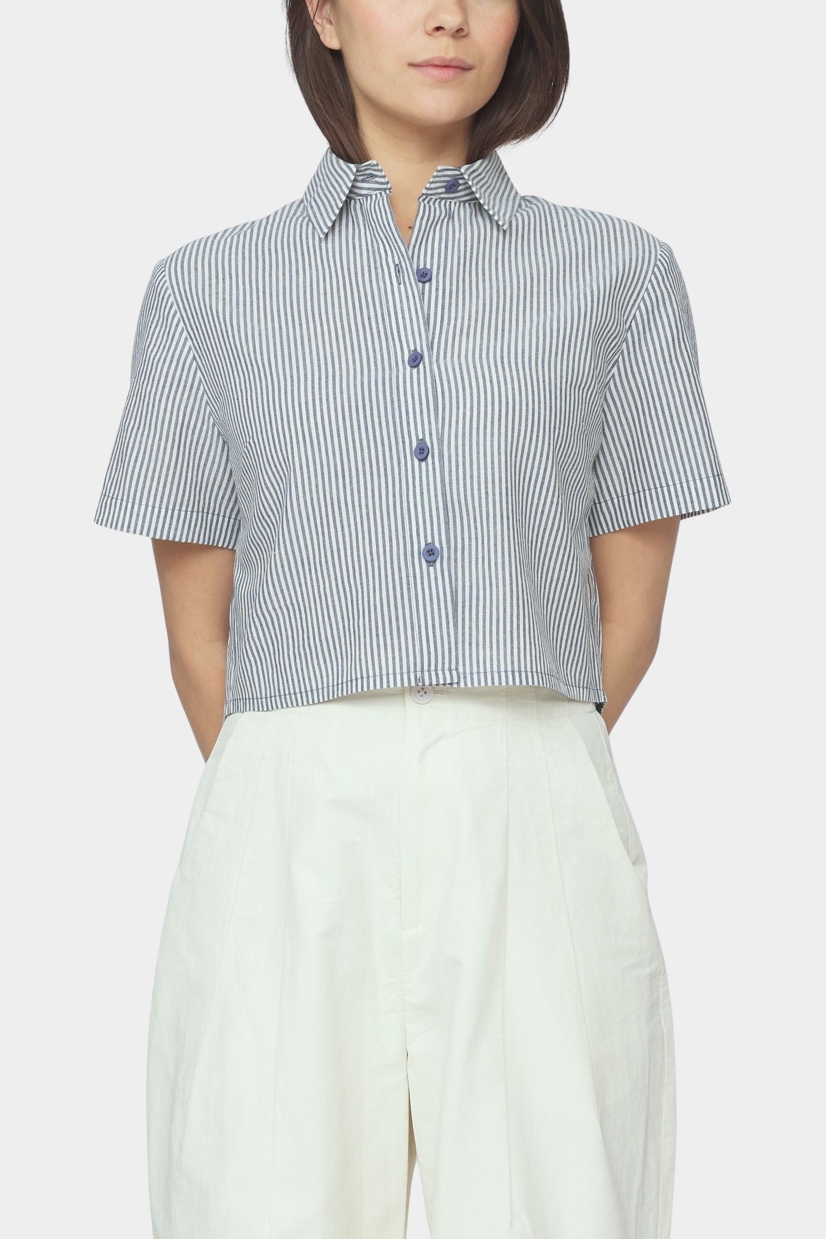 Close up front view of navy striped cropped shirt with short sleeves, pointed collar, and button front