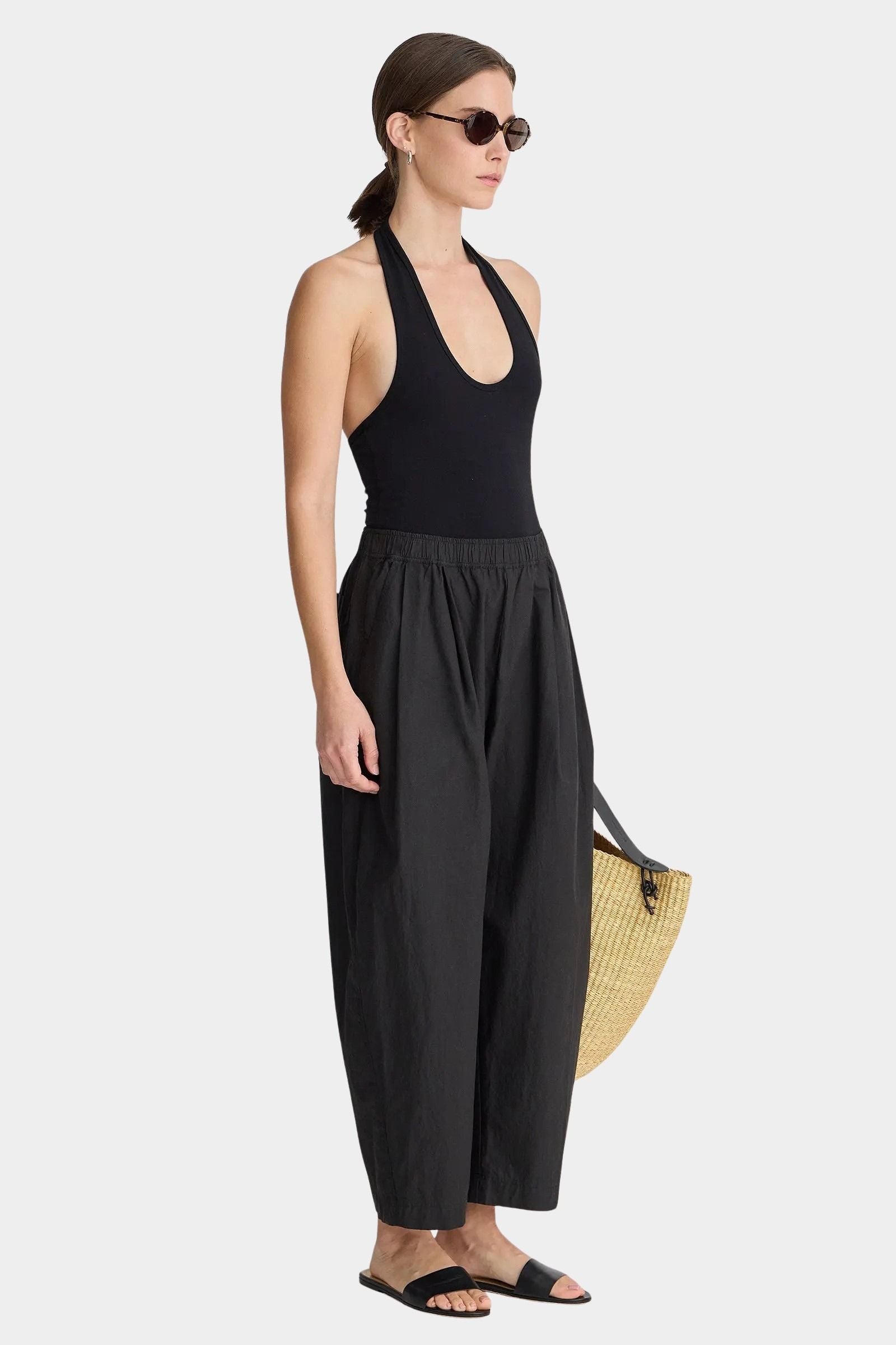 Side view of Apiece Apart Spa Pleat Pant Black lightweight relaxed trouser with gathered waistband