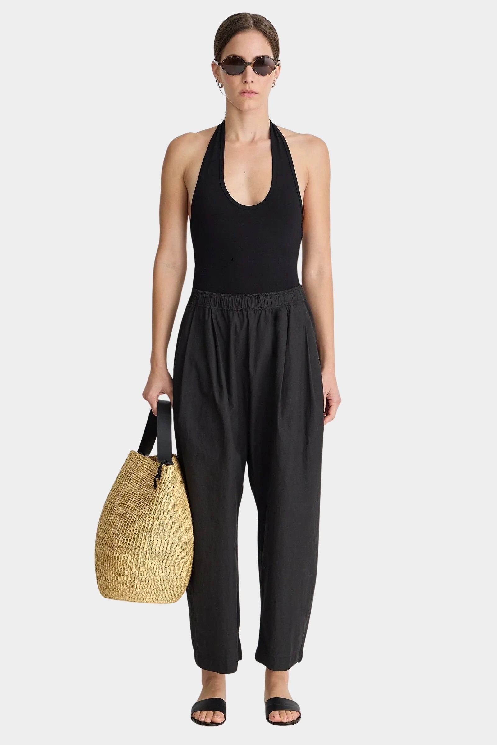 Apiece Apart Spa Pleat Pant Black relaxed cotton pull-on pant styled with halter bodysuit and woven tote at YUCCA Denver