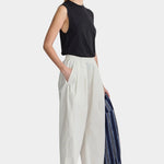 Apiece Apart Spa Pleat Pant Cream angled side view with relaxed cropped fit and organic cotton texture