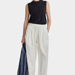 Apiece Apart Spa Pleat Pant Cream front styling view with elastic waist barrel leg silhouette and organic cotton fabrication