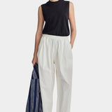Apiece Apart Spa Pleat Pant Cream front styling view with elastic waist barrel leg silhouette and organic cotton fabrication