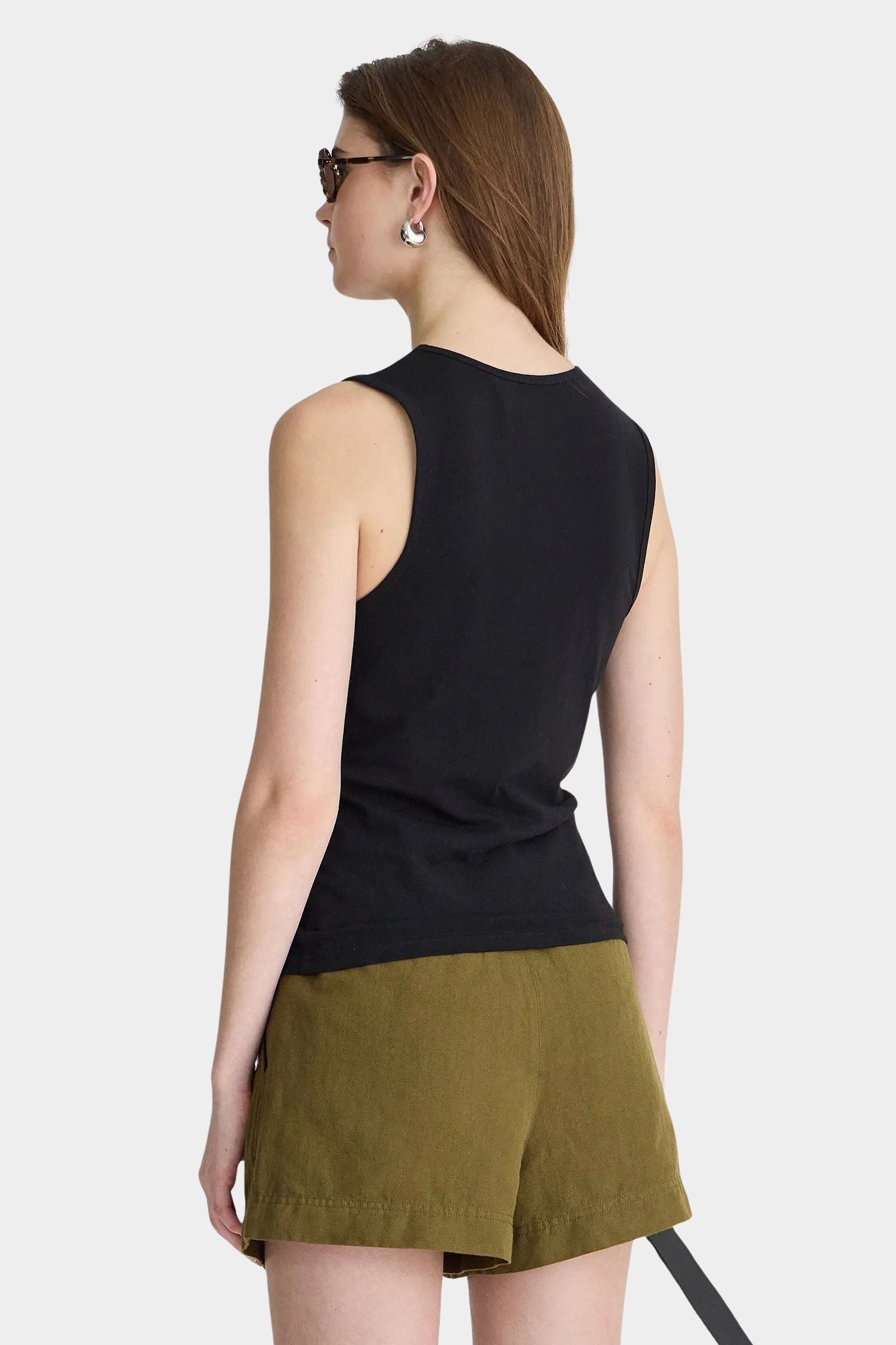 Apiece Apart Uri Low-Cut Tank Black back view with sleeveless fitted silhouette and olive shorts
