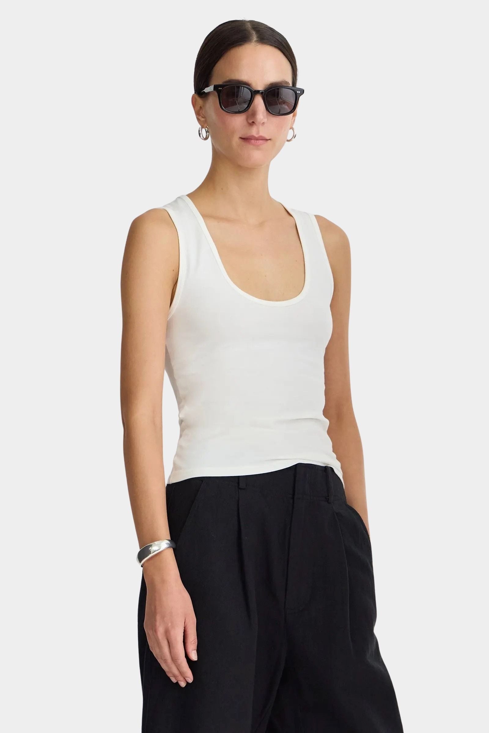 Cream Uri Low-Cut Tank by Apiece Apart styled with black trousers and silver jewelry