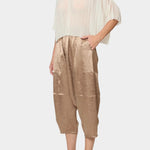 Atelier Delphine Kiko pant in latte worn with sheer top showing cropped wide leg fit and elastic waist