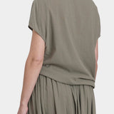 Black Crane asymmetric cotton gauze top cement back view showing soft drape and short sleeve silhouette