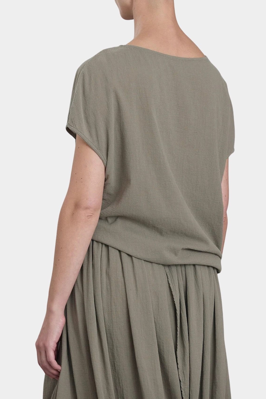 Black Crane asymmetric cotton gauze top cement back view showing soft drape and short sleeve silhouette