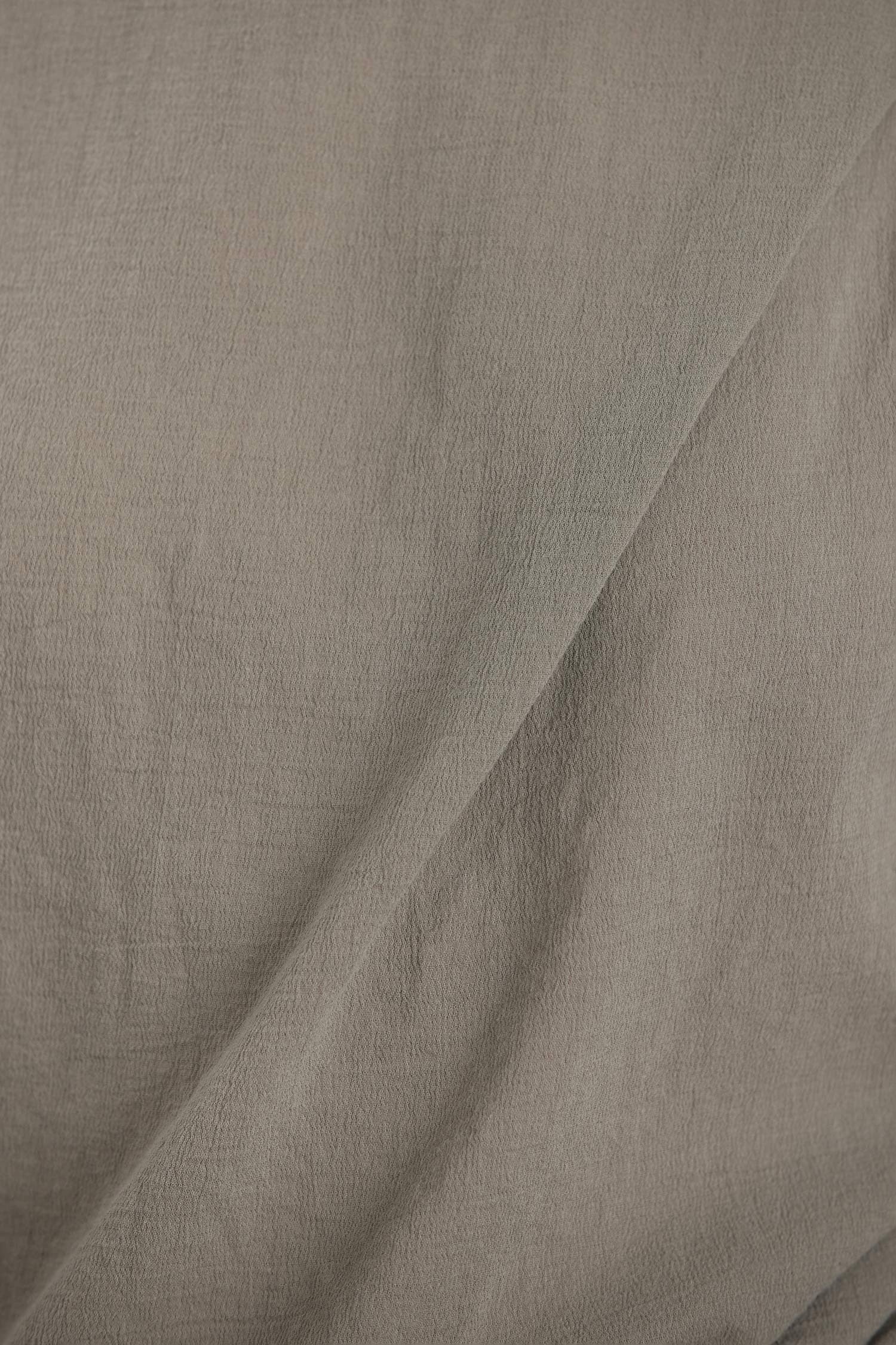 Black Crane cotton gauze fabric in cement color close up showing soft textured weave