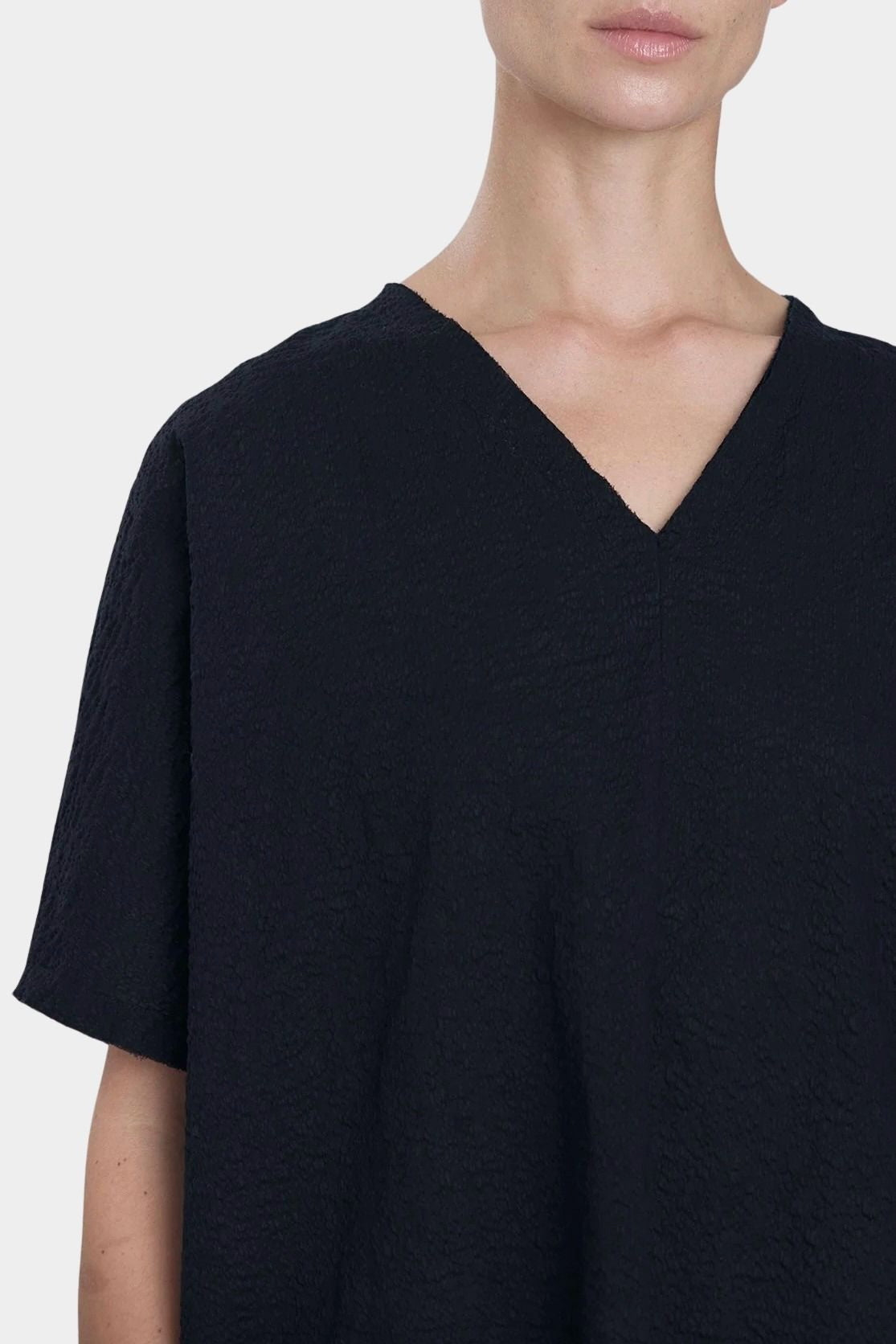 Black Crane v neck dress midnight neckline detail raw edge v neck cotton close up