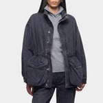 Close up of the DALA Mountain Jacket in Hurricane, worn open over a gray hoodie with matching denim, from YUCCA Denver.