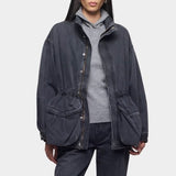 Close up of the DALA Mountain Jacket in Hurricane, worn open over a gray hoodie with matching denim, from YUCCA Denver.