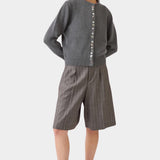 Model wearing the DEMYLEE Soleil cotton cardigan in charcoal with tailored knee length shorts
