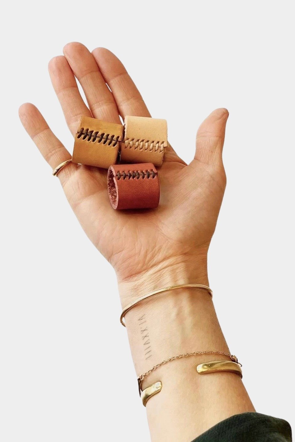 Eco Raw Studio leather bandana cuff dark brown worn on wrist holding bandana