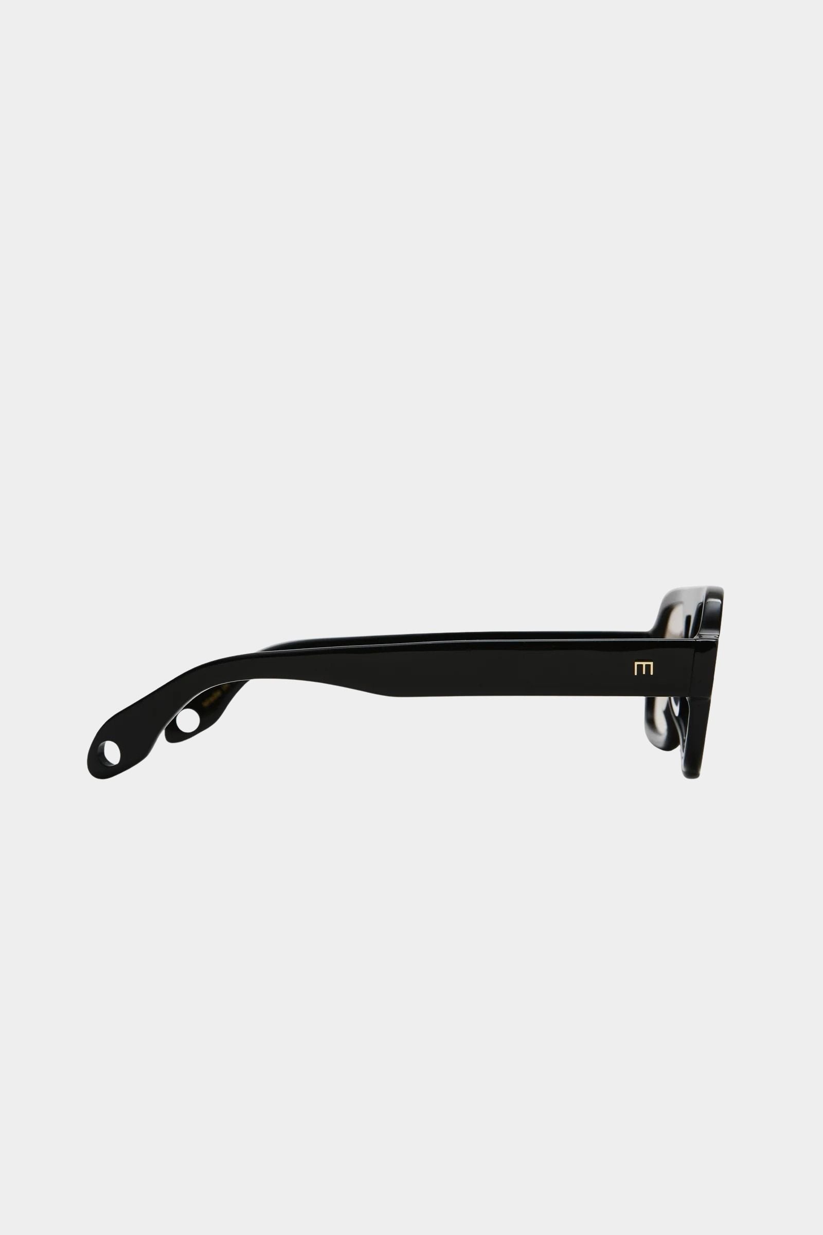 Side profile of Elisa Johnson Jane Mini sunglasses in gloss black acetate with thick temples and tinted lenses