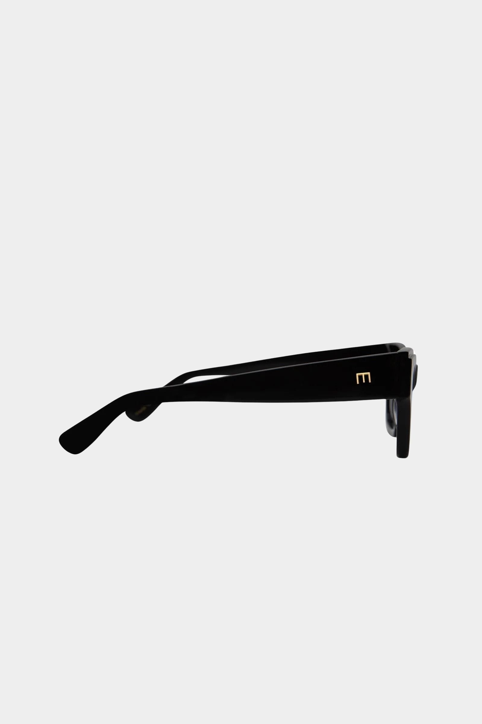 Side profile of Elisa Johnson Rae sunglasses in gloss black acetate with slim temples and tonal black lenses