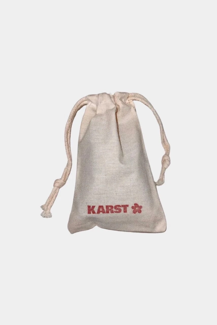 KARST branded fabric drawstring pouch included with hair clip