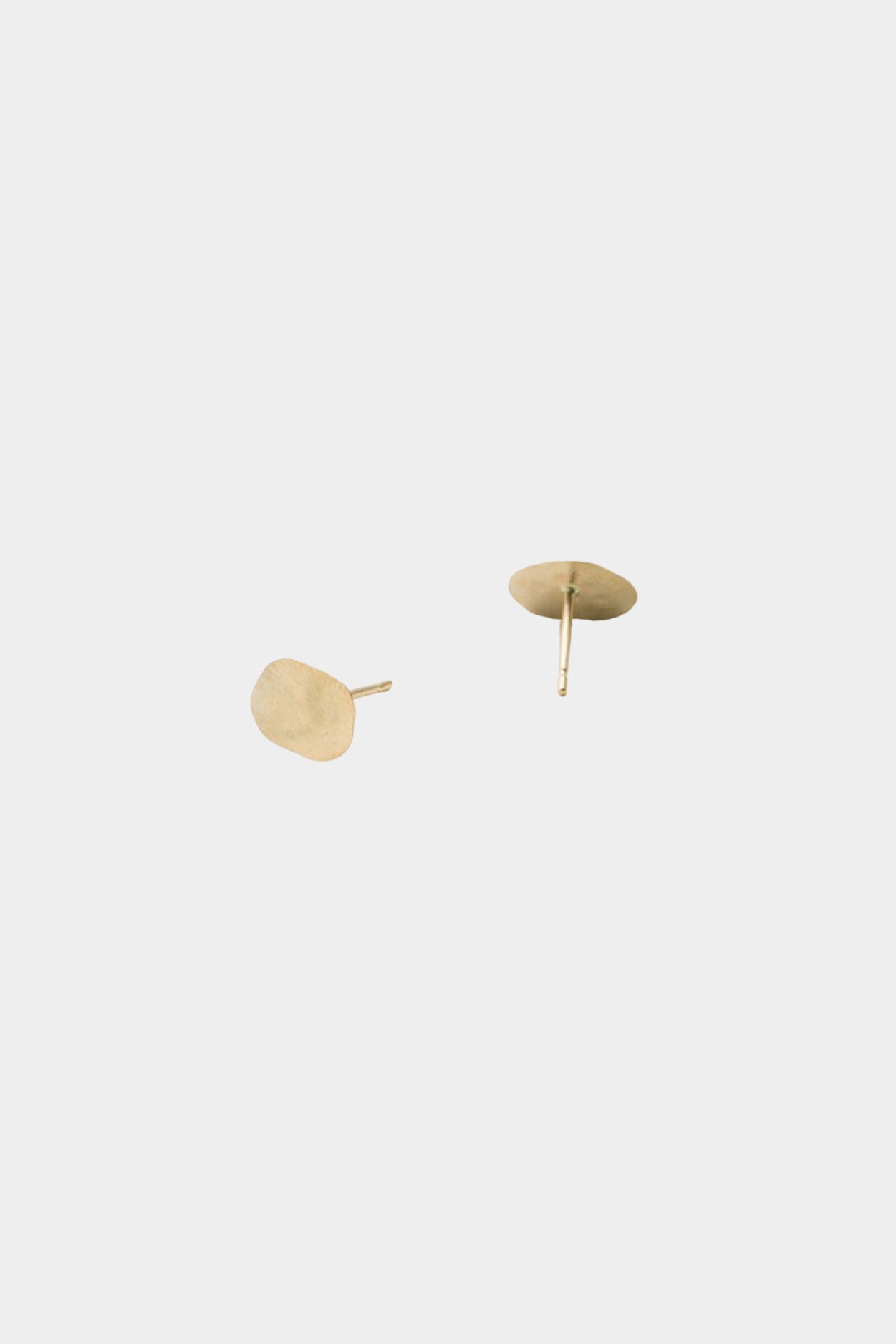 Gold disc stud earrings with post backing and matte textured surface detail.
