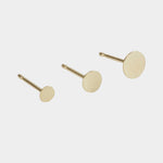 Gold disc stud earrings shown in assorted sizes for layering and stacking.