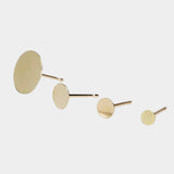 Minimalist gold disc stud earrings in multiple sizes with matte finish.