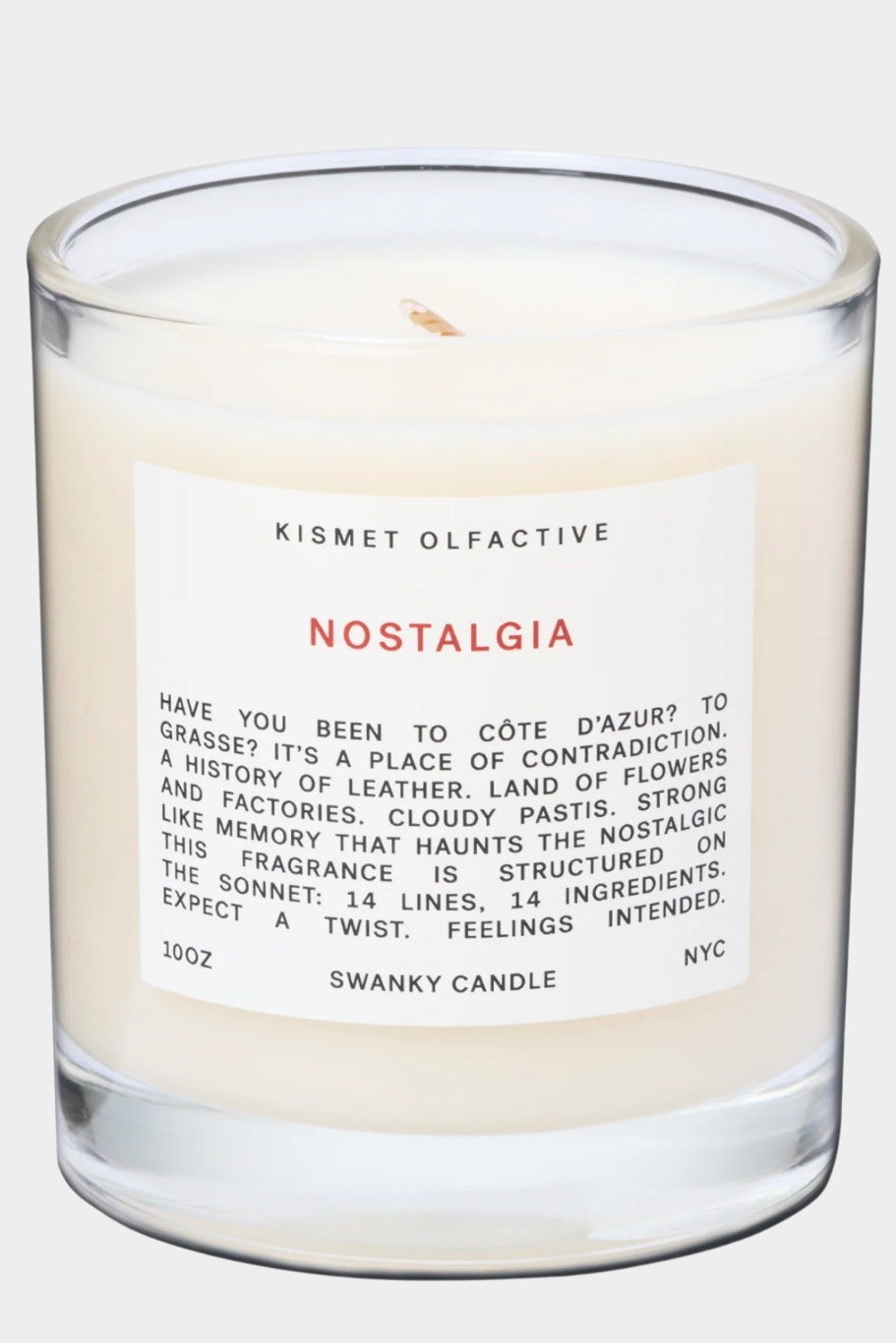 Kismet Olfactive Nostalgia Candle in clear glass vessel with organic wax blend