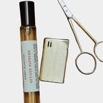 Kismet Olfactive Vetiver Supreme eau de parfum 10ml travel spray with cap removed next to metal scissors on neutral background