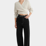 Full front view of the Oatmeal Kowtow Composure Cardigan tied above black wide leg trousers.