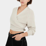 Front close view of the Oatmeal Kowtow Composure Cardigan showing its wrap neckline and cropped hem.