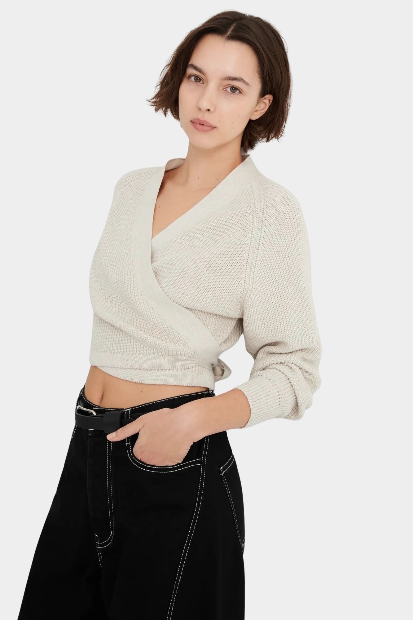 Front close view of the Oatmeal Kowtow Composure Cardigan showing its wrap neckline and cropped hem.