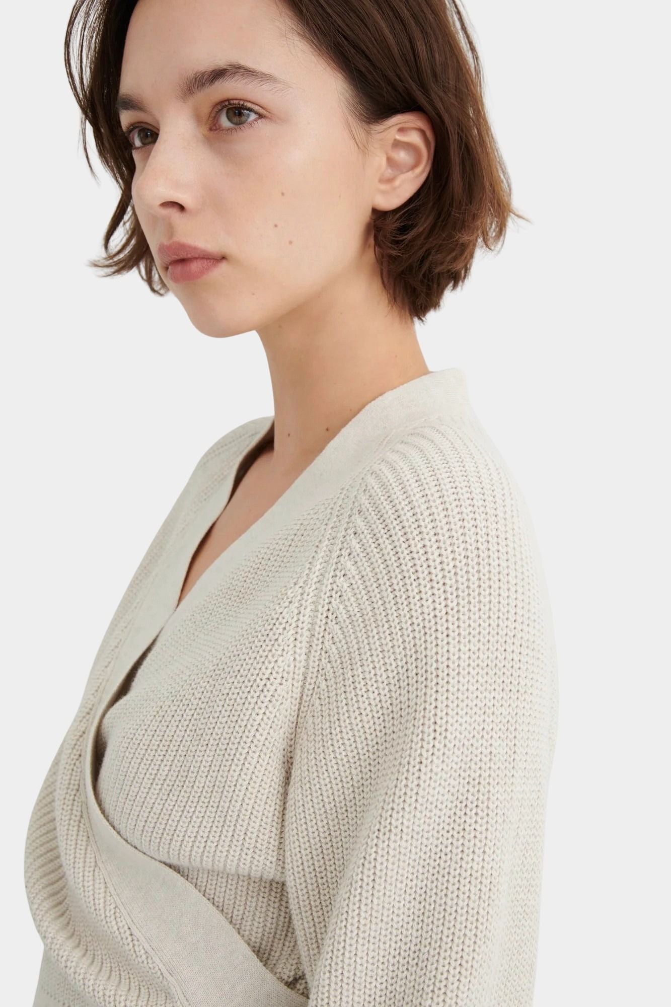 Side close view of the Oatmeal Kowtow Composure Cardigan showing the textured shoulder and wrap edge.