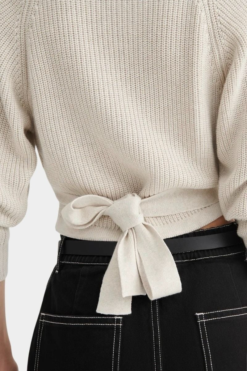 Close back detail of the Oatmeal Kowtow Composure Cardigan showing the tied waist and tuck stitch knit.