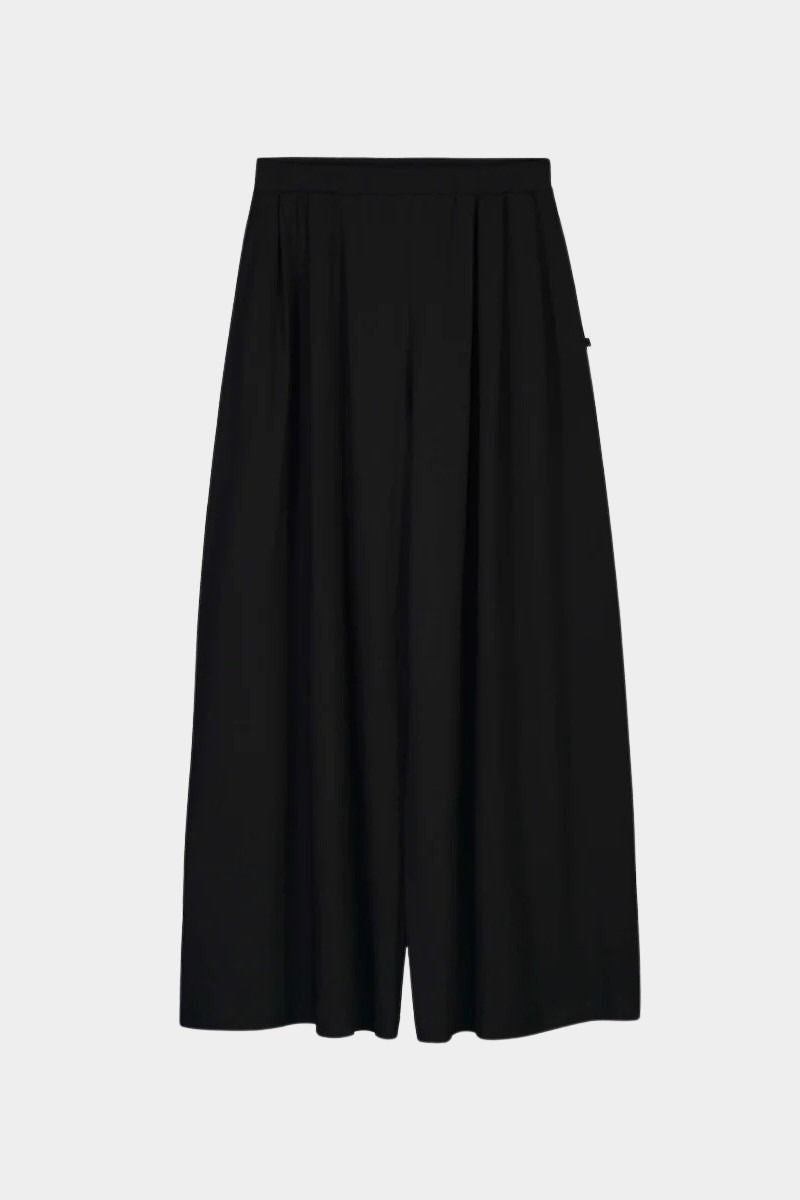 Front product view of the black Kowtow Drape Pant showing its pleats and full, wide legs.