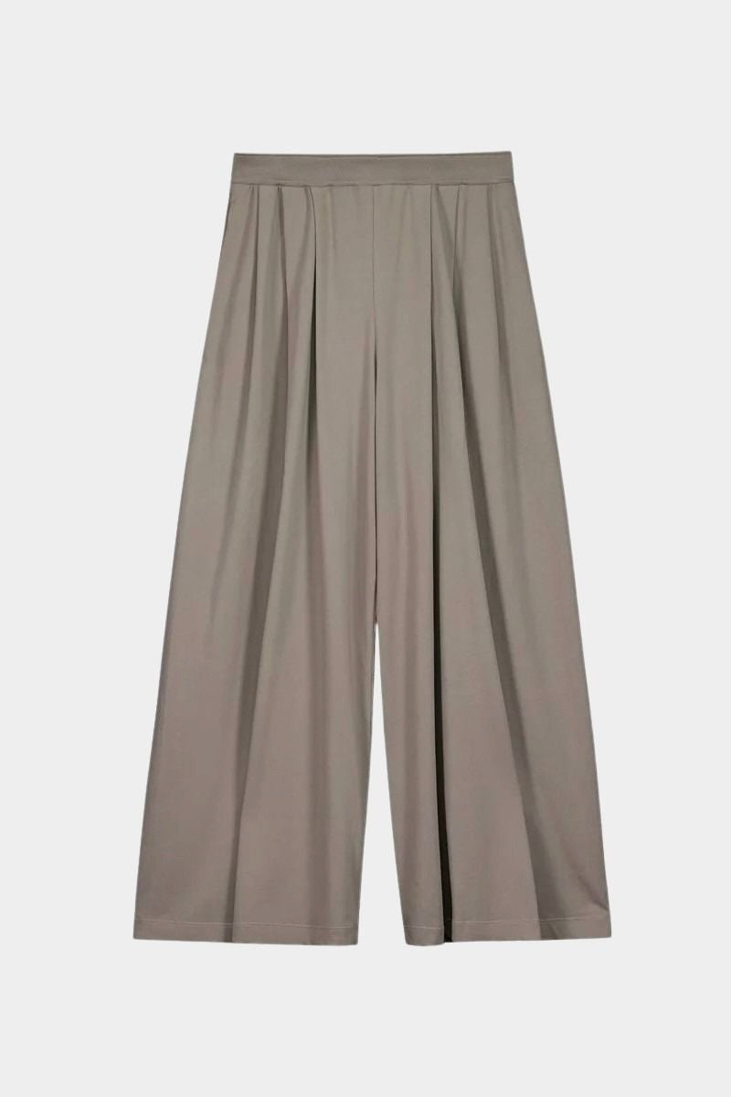 Front product view of the Kowtow Drape Pant in Flint, showing the pleated wide legs and elastic waistband at YUCCA Denver.