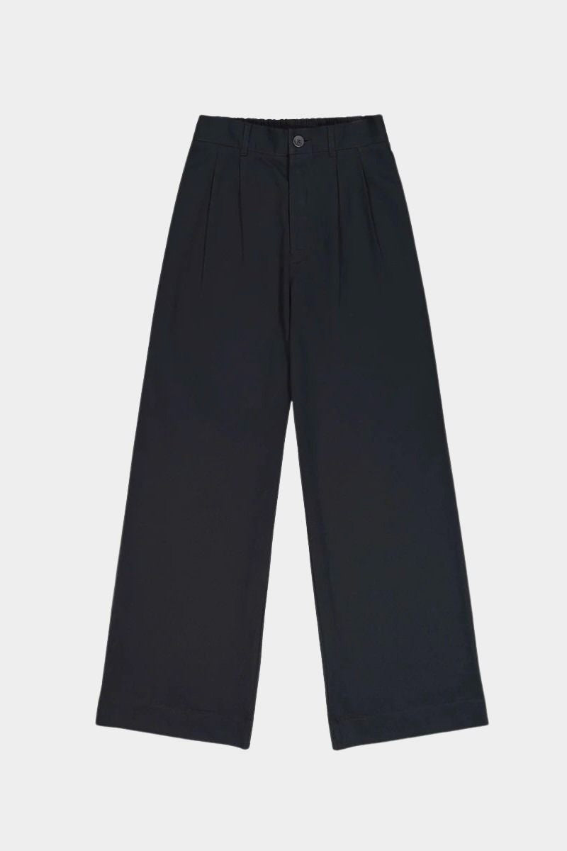 Close view of the black Kowtow Franz Pant showing its high waistband, nut button and front pleats at YUCCA Denver.