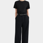 Full front view of the black Kowtow Franz Pant showing its high rise and wide straight silhouette.
