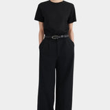 Full front view of the black Kowtow Franz Pant showing its high rise and wide straight silhouette.